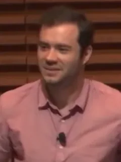 Andrej Karpathy speaking in an OpenAI video still.
